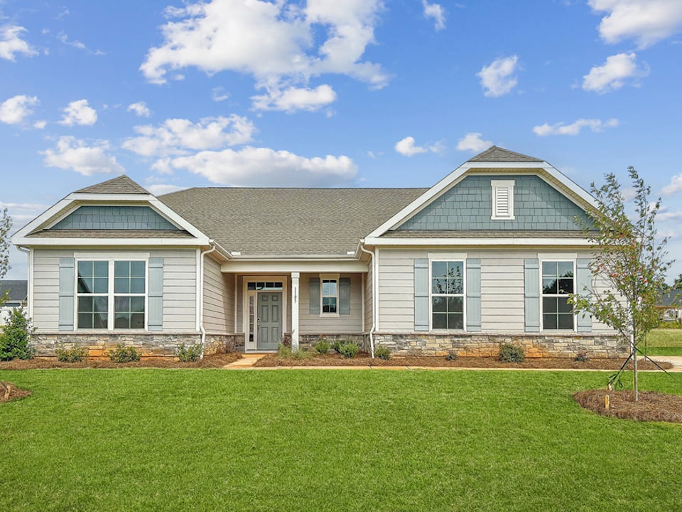 A house with a lawn in front.
