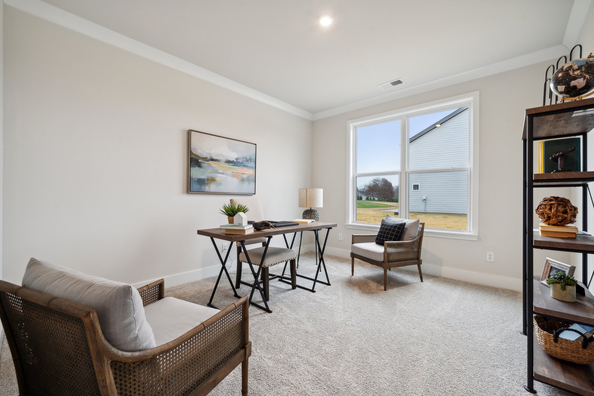 A living room with a table and chairs.