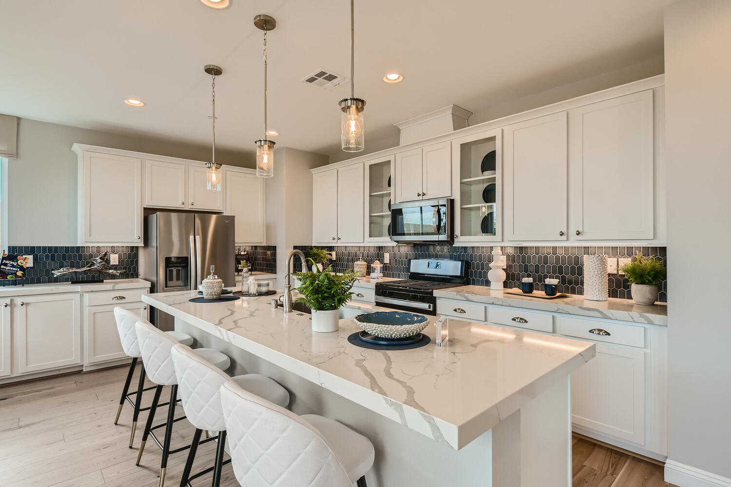 A kitchen with white cabinets.