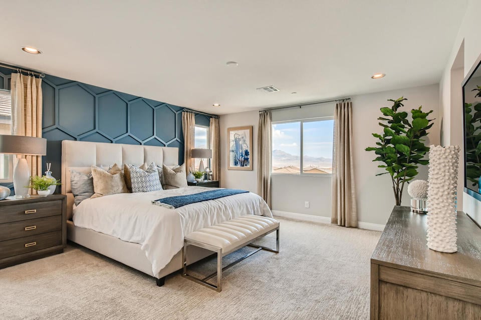 A bedroom with a large window.