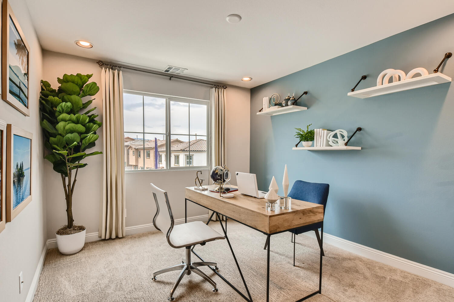 A dining room with a table and chairs.