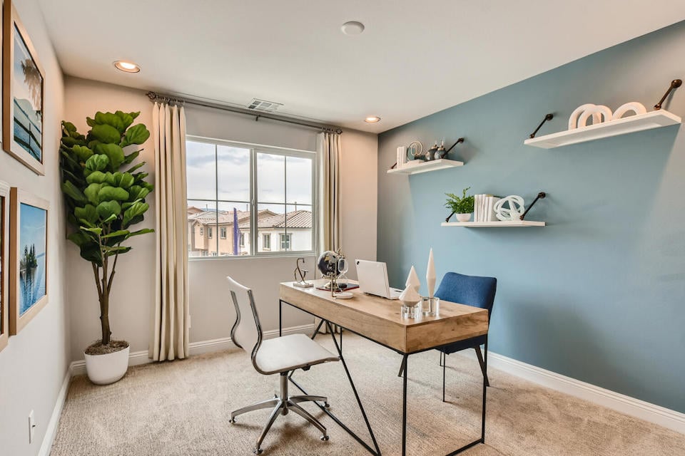 A dining room with a table and chairs.