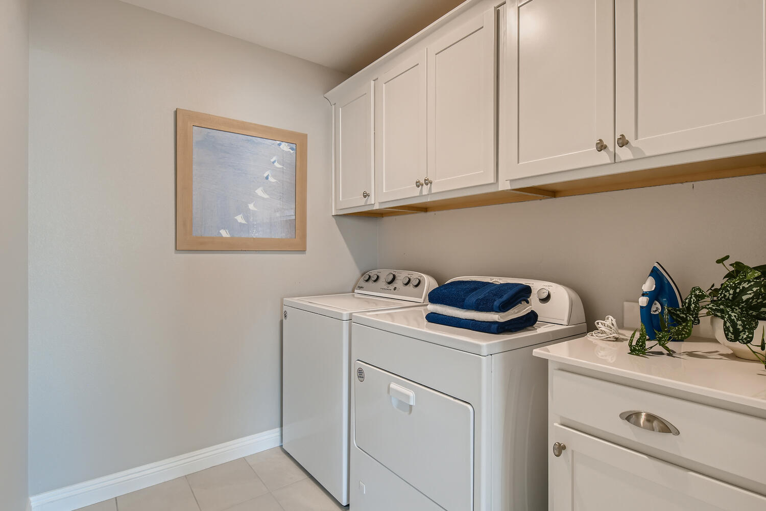 A kitchen with white cabinets.