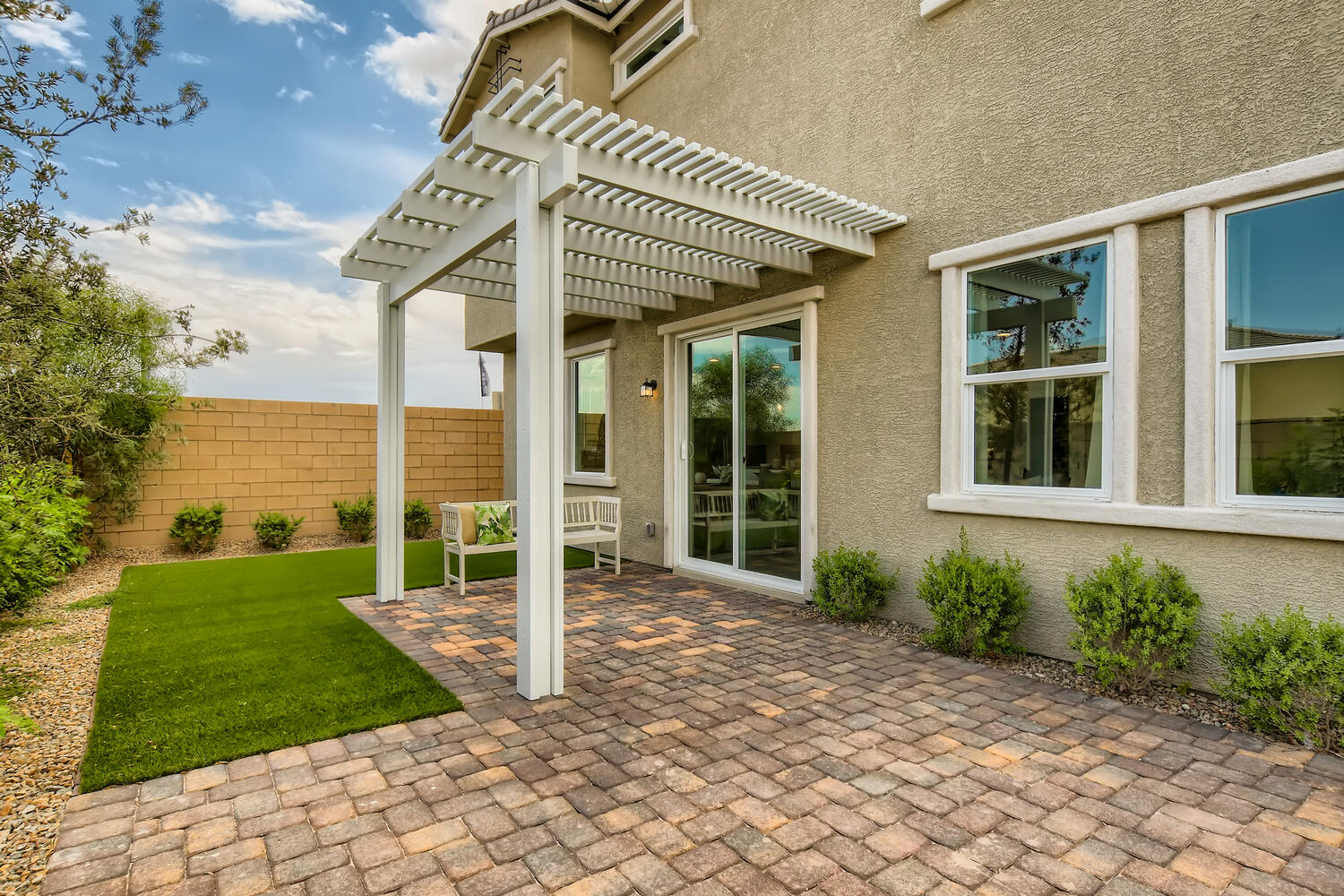 A house with a brick driveway.