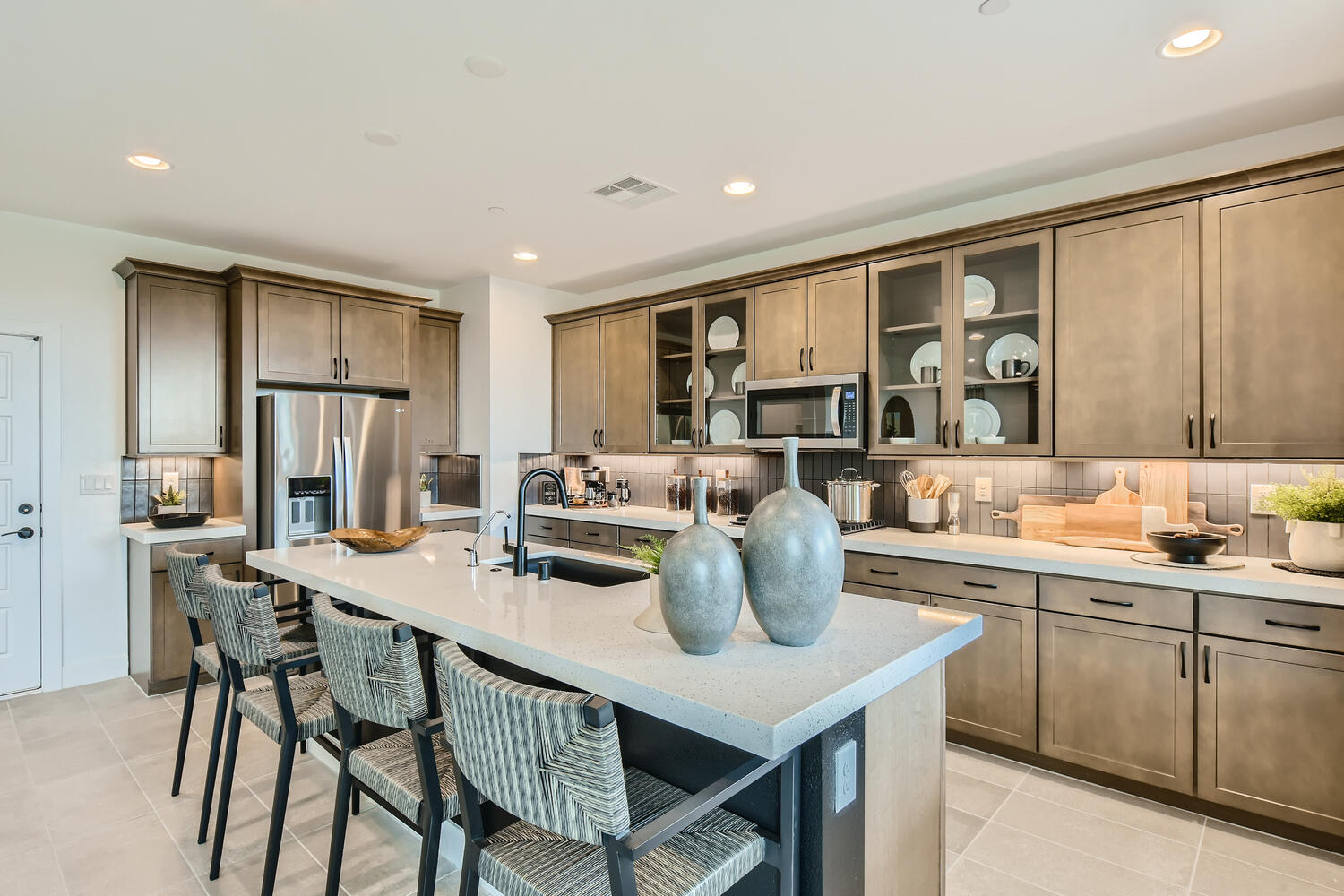 A kitchen with a marble island.