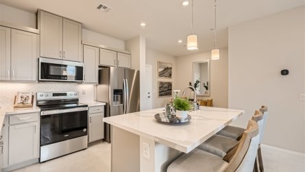 A kitchen with white cabinets.