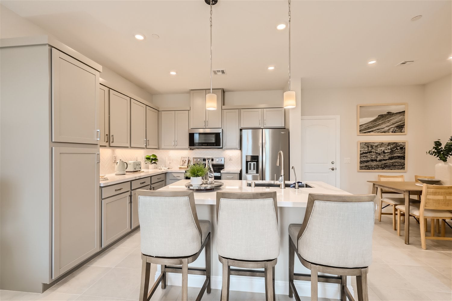 A kitchen with white cabinets.