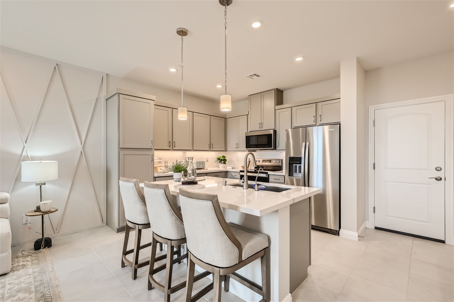 A kitchen with white cabinets.