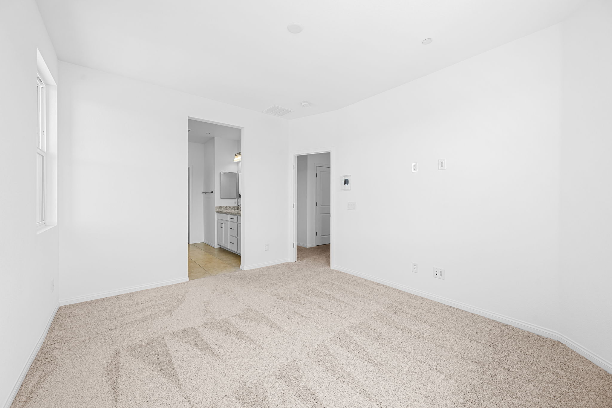 A long hallway with white walls.