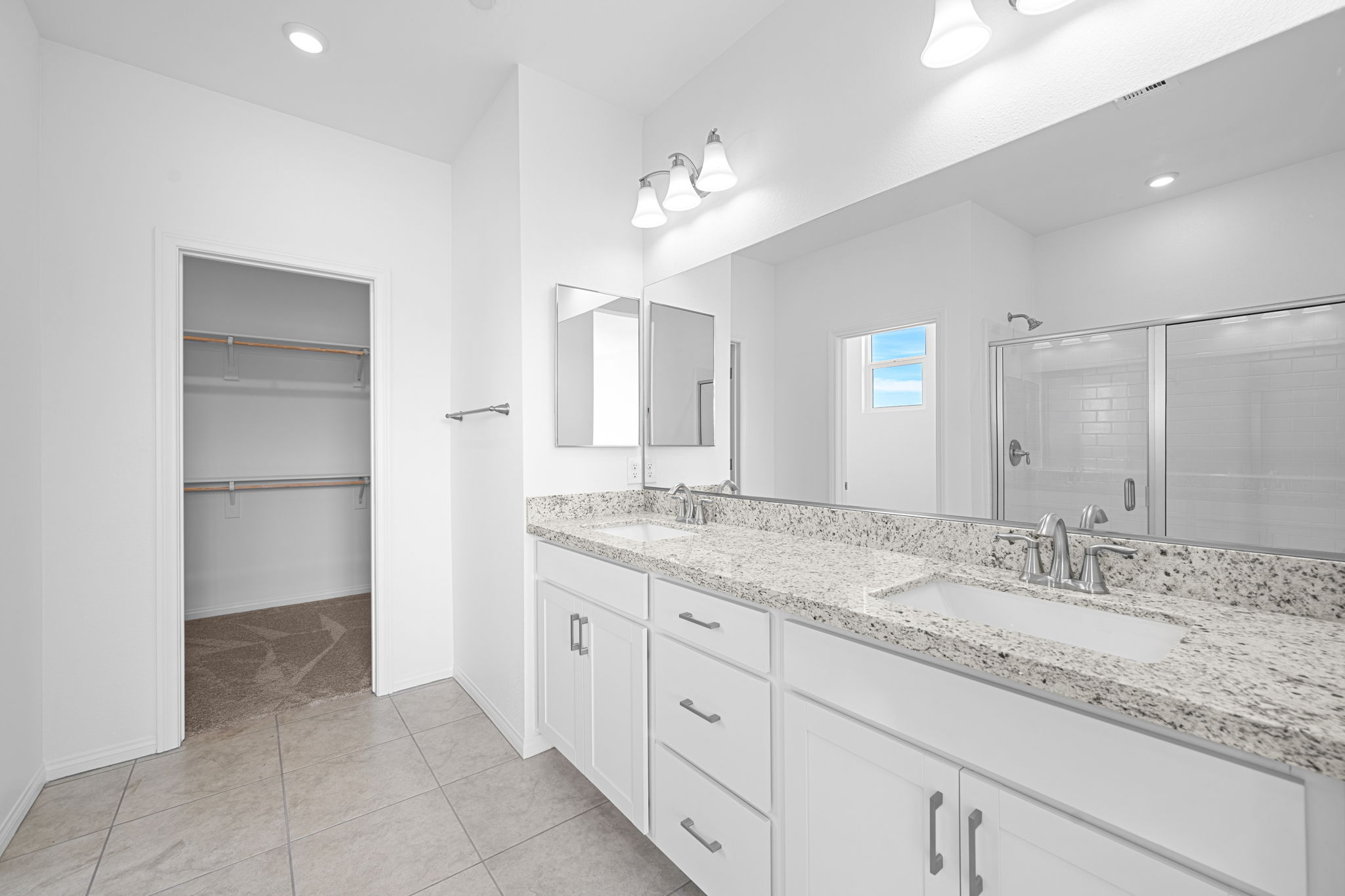 A bathroom with a marble countertop.