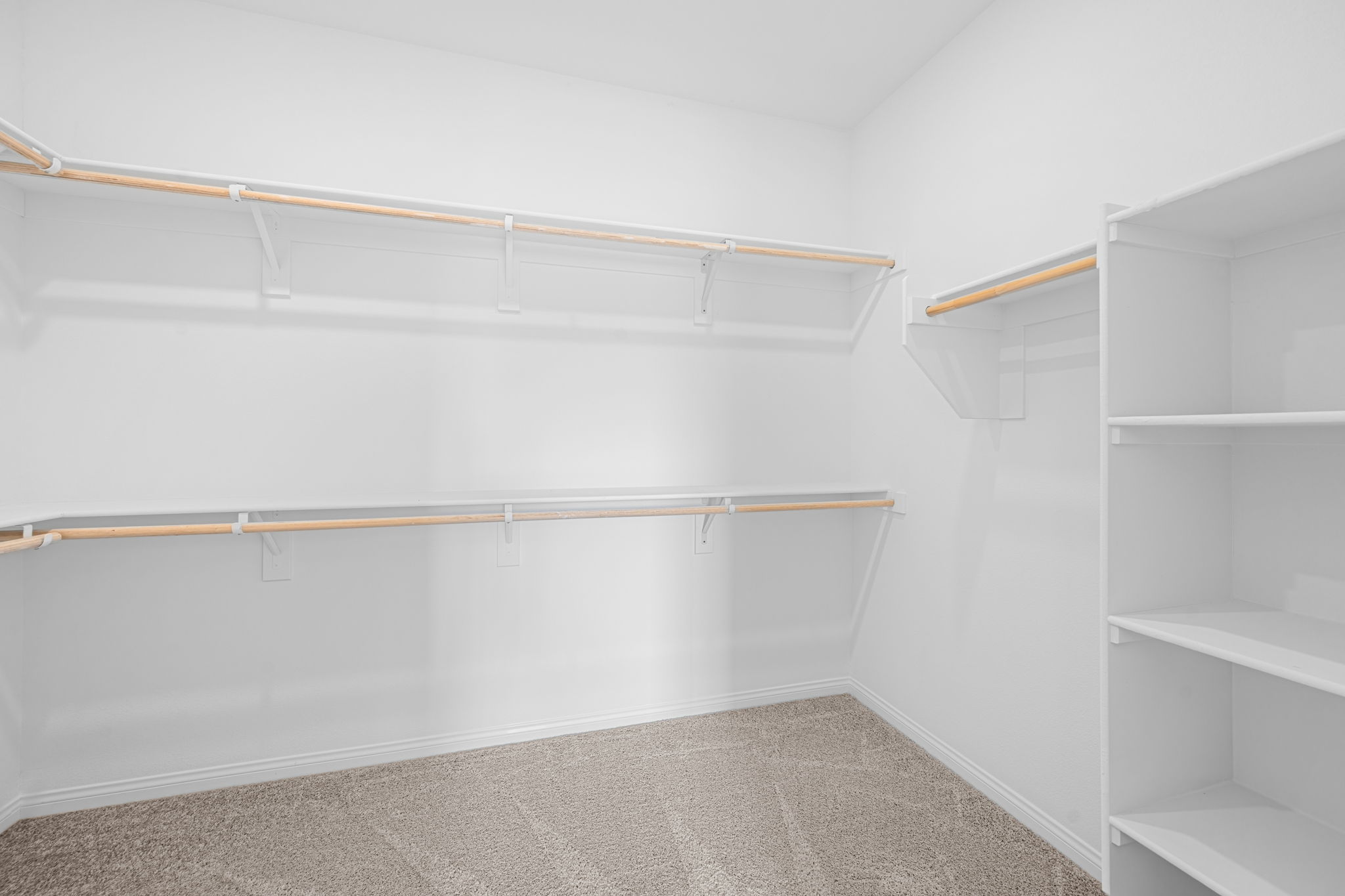 A white room with white shelves.