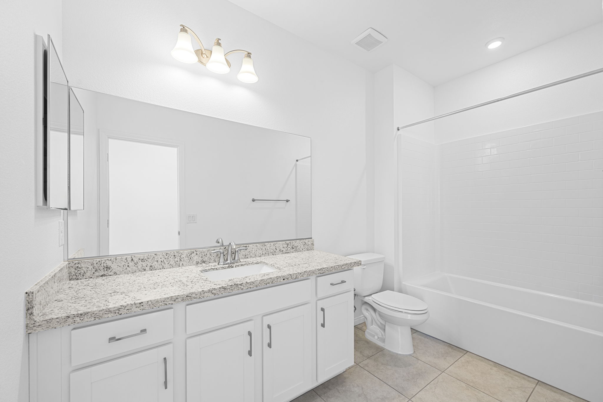 A bathroom with a tub sink and toilet.