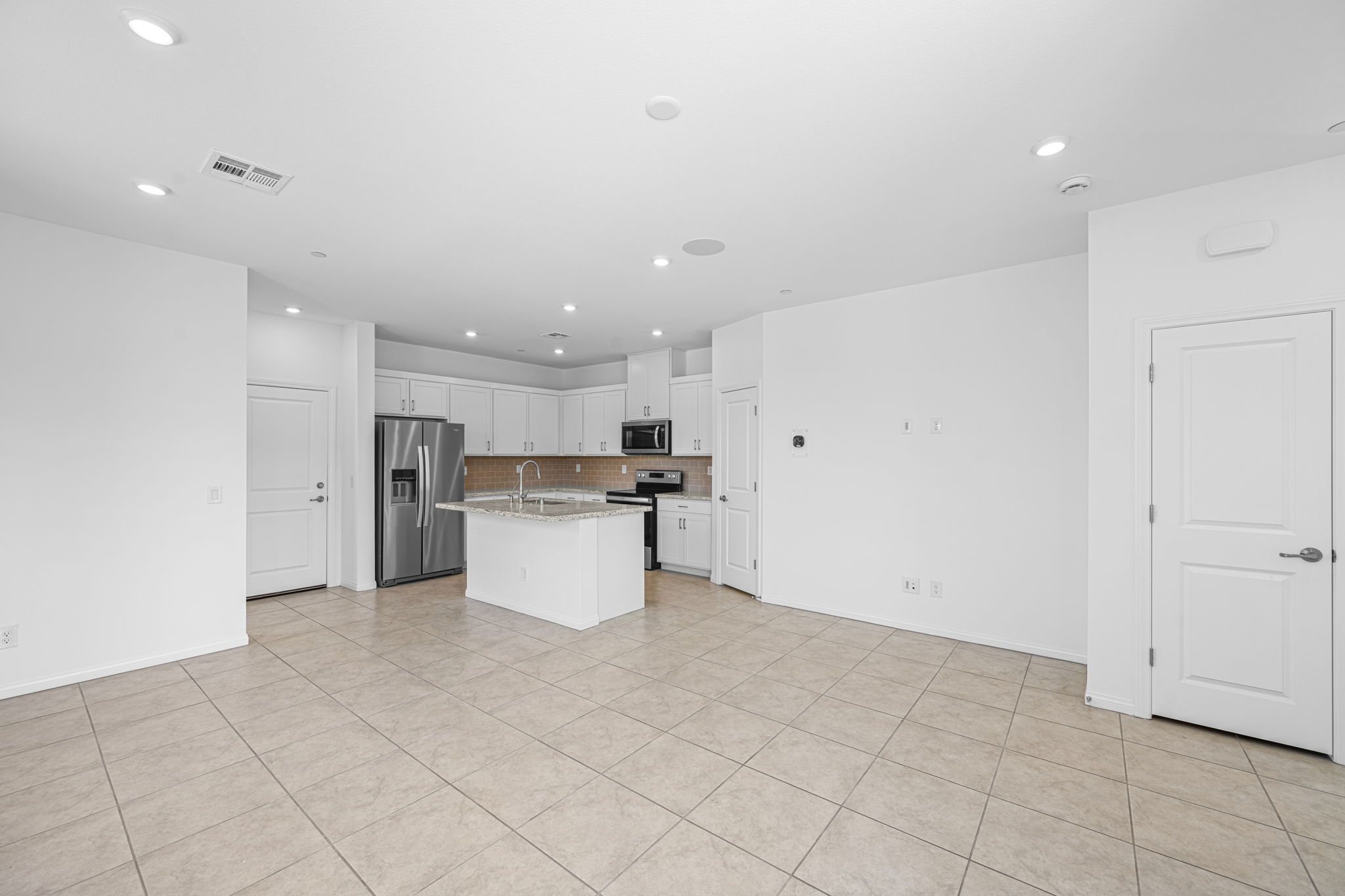 A large kitchen with white cabinets.