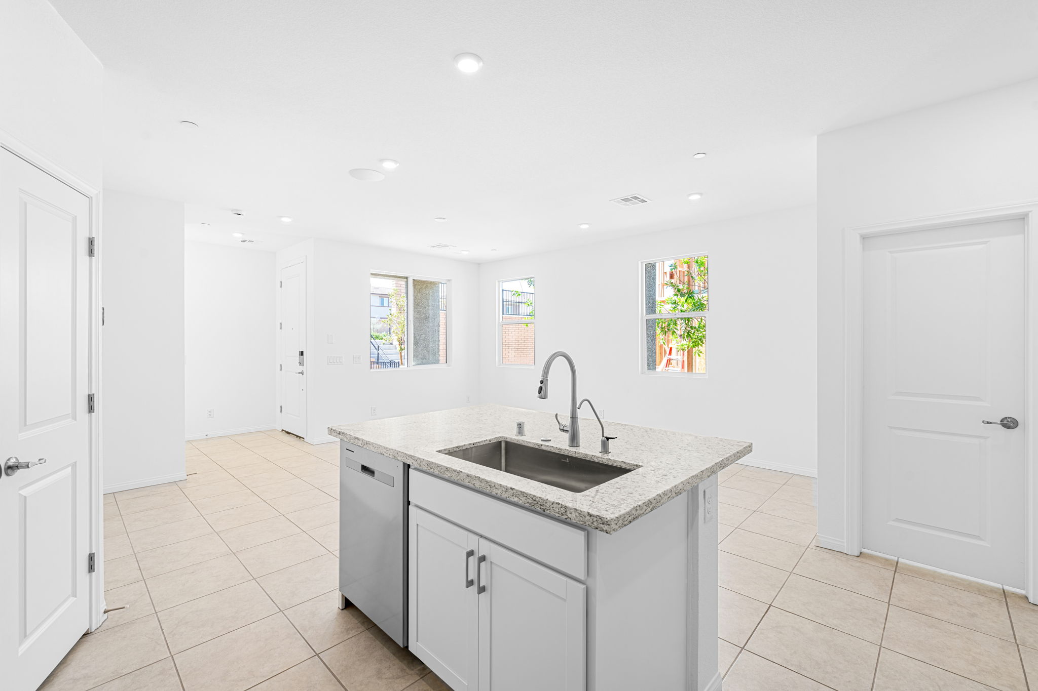A kitchen with white cabinets.