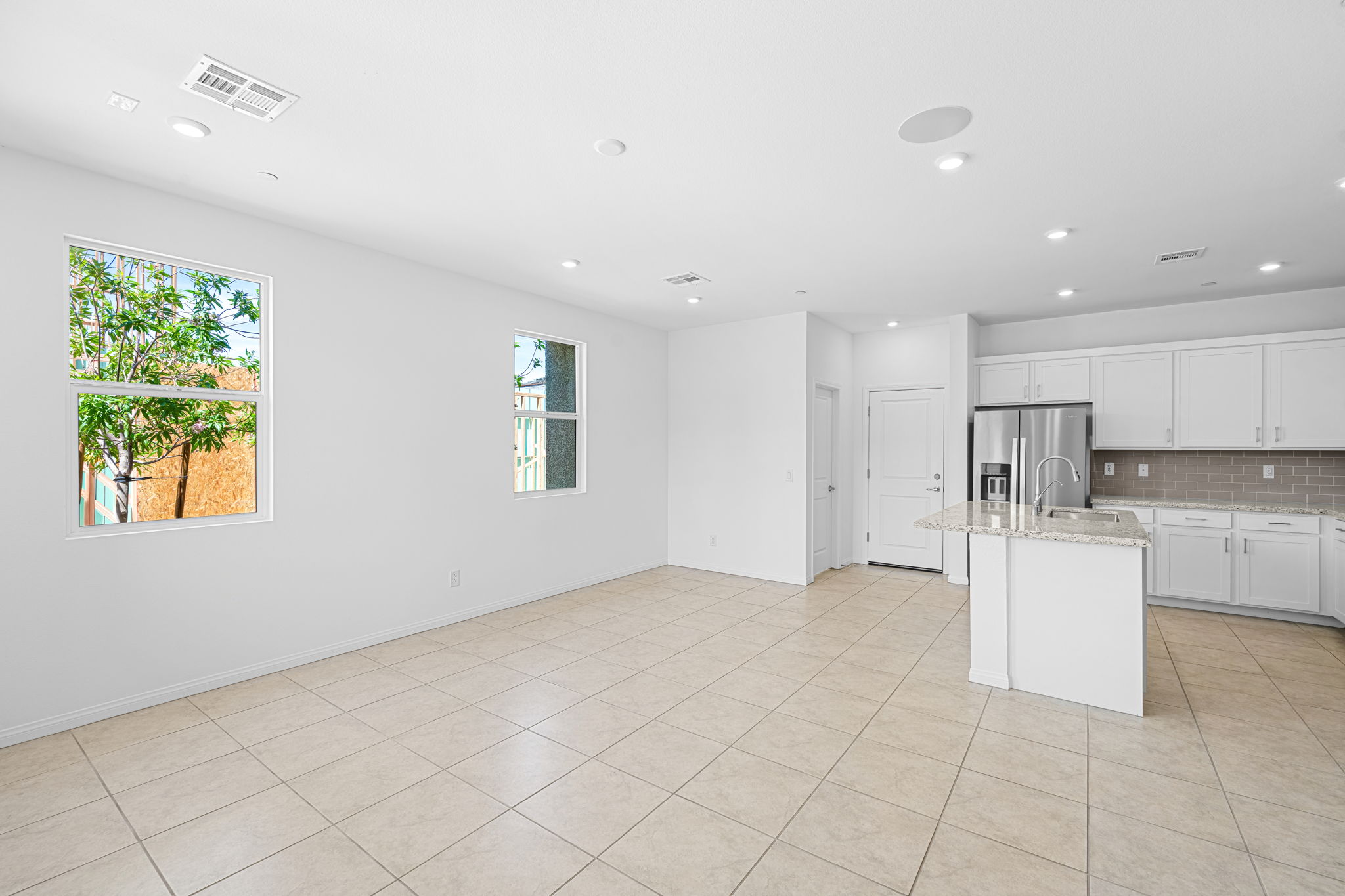 A large kitchen with white cabinets.