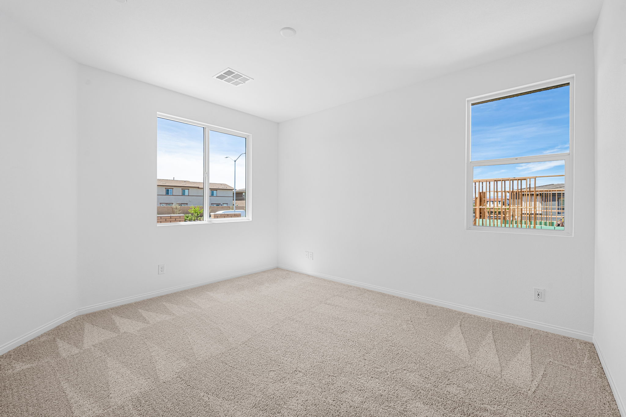 A room with a window and a carpet.