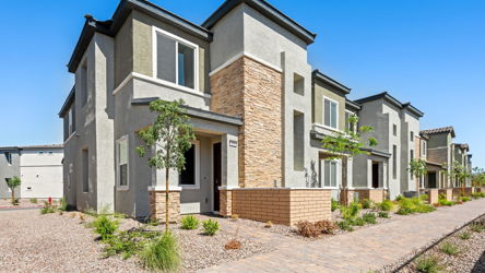 A brick building with trees and bushes.