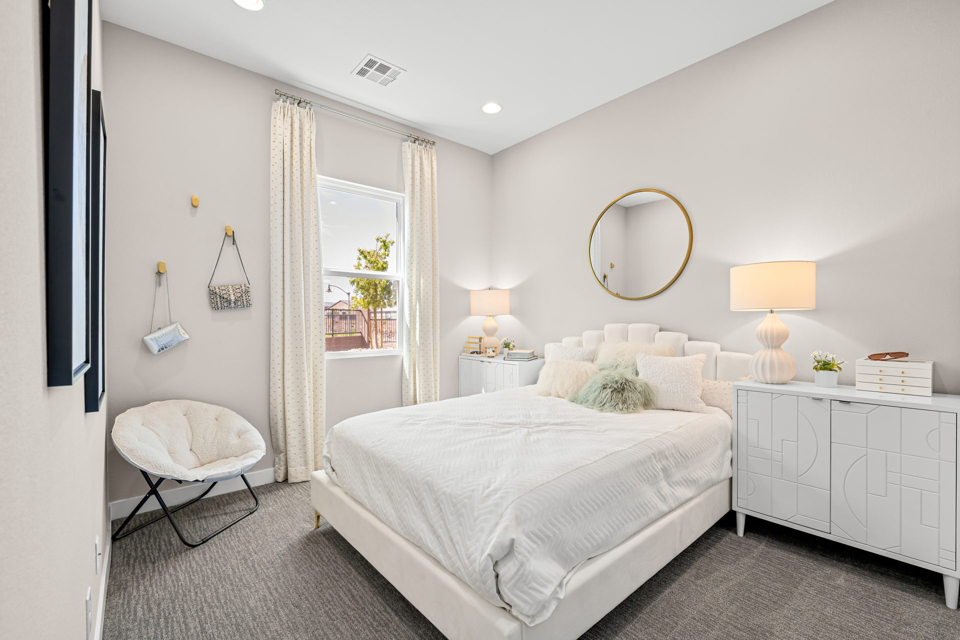 A bedroom with a bed and a chair.