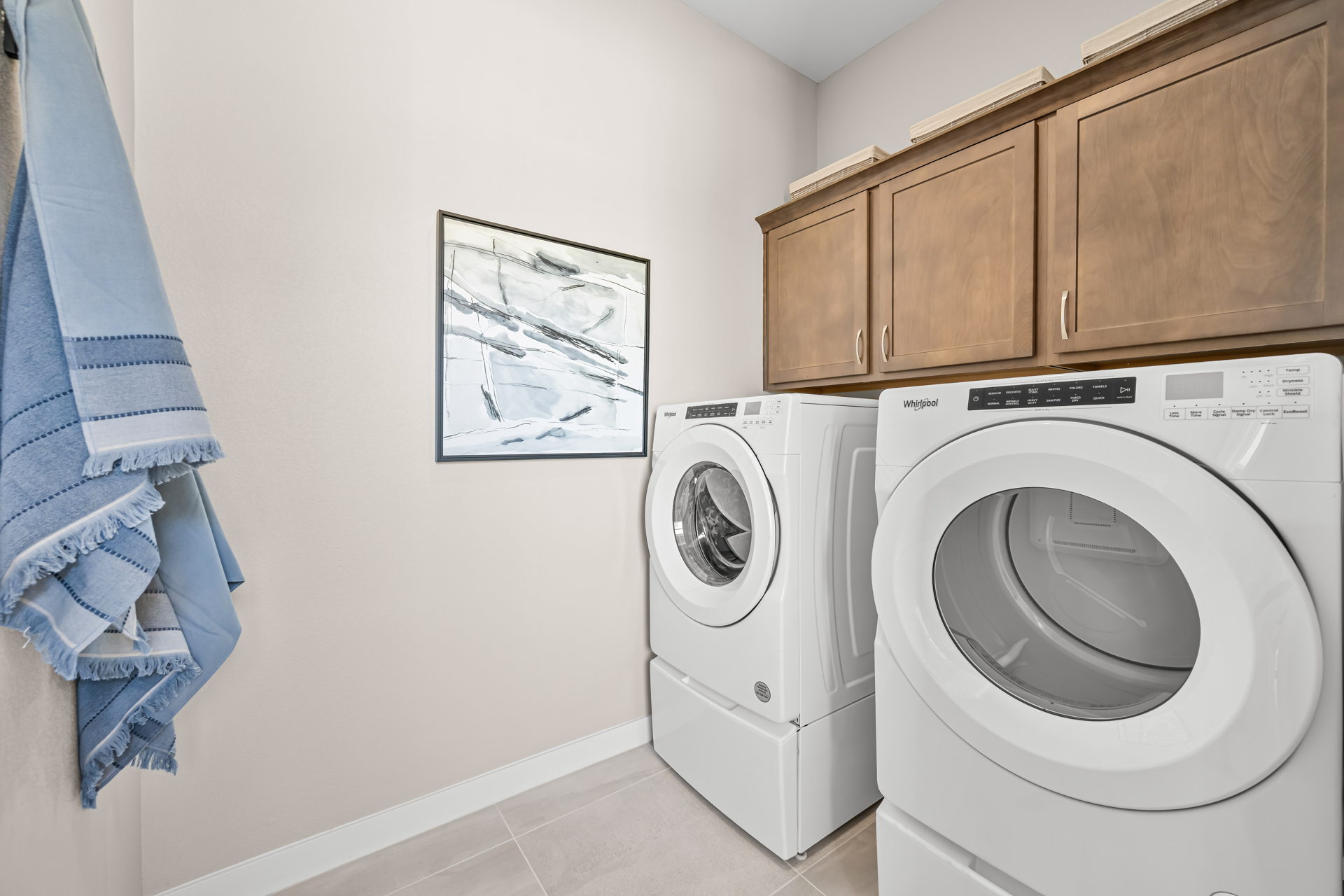 A washing machine and a dryer in a room.