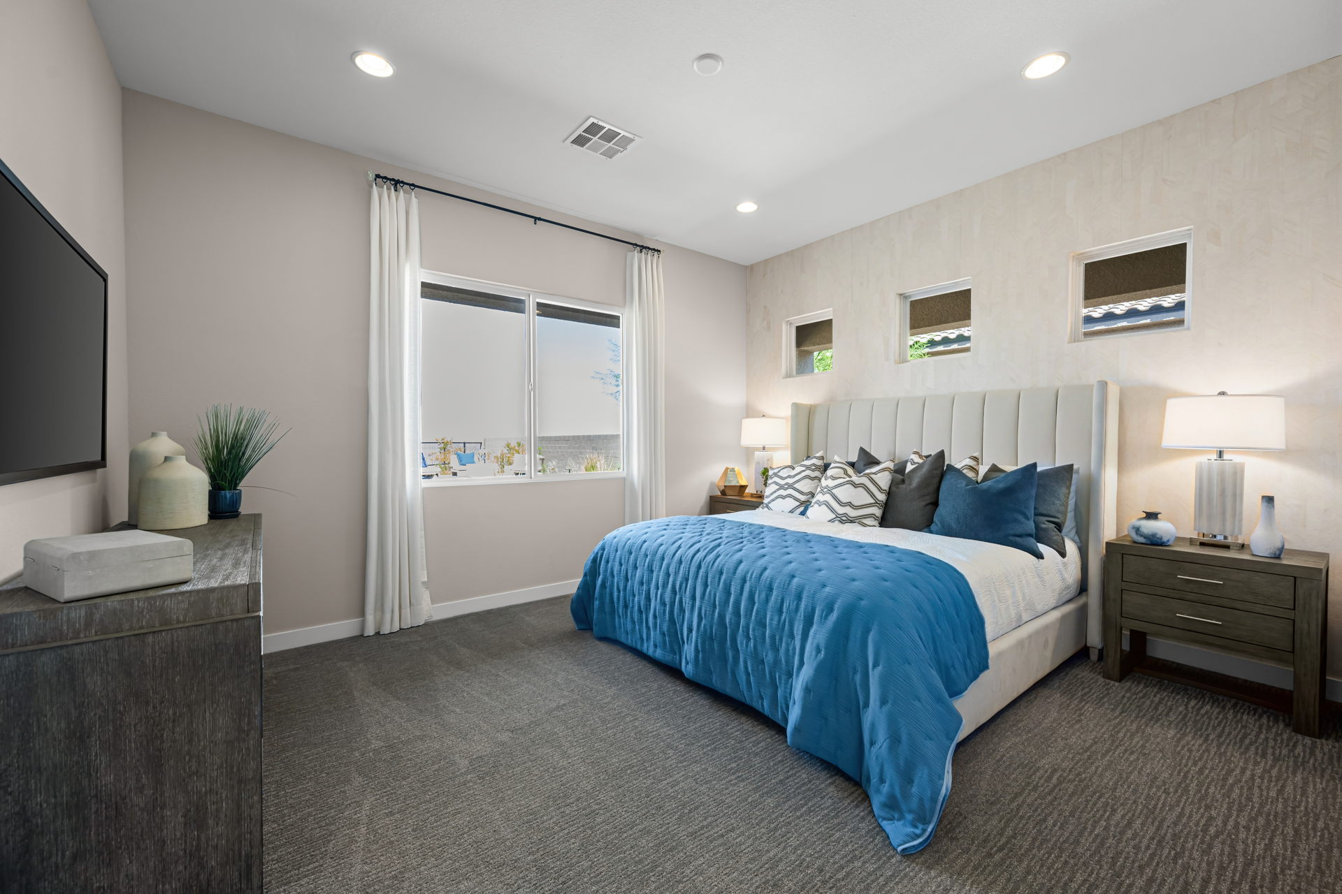 A bedroom with a bed and a tv.
