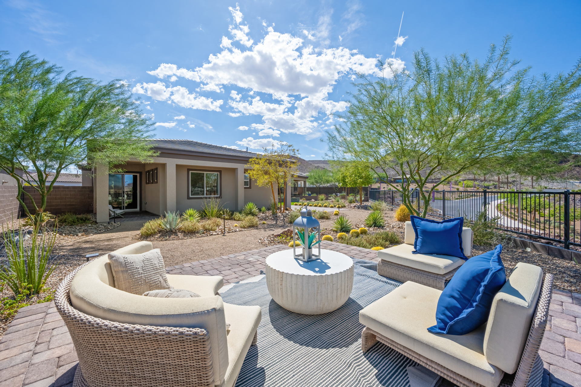 A patio with a fountain and chairs.