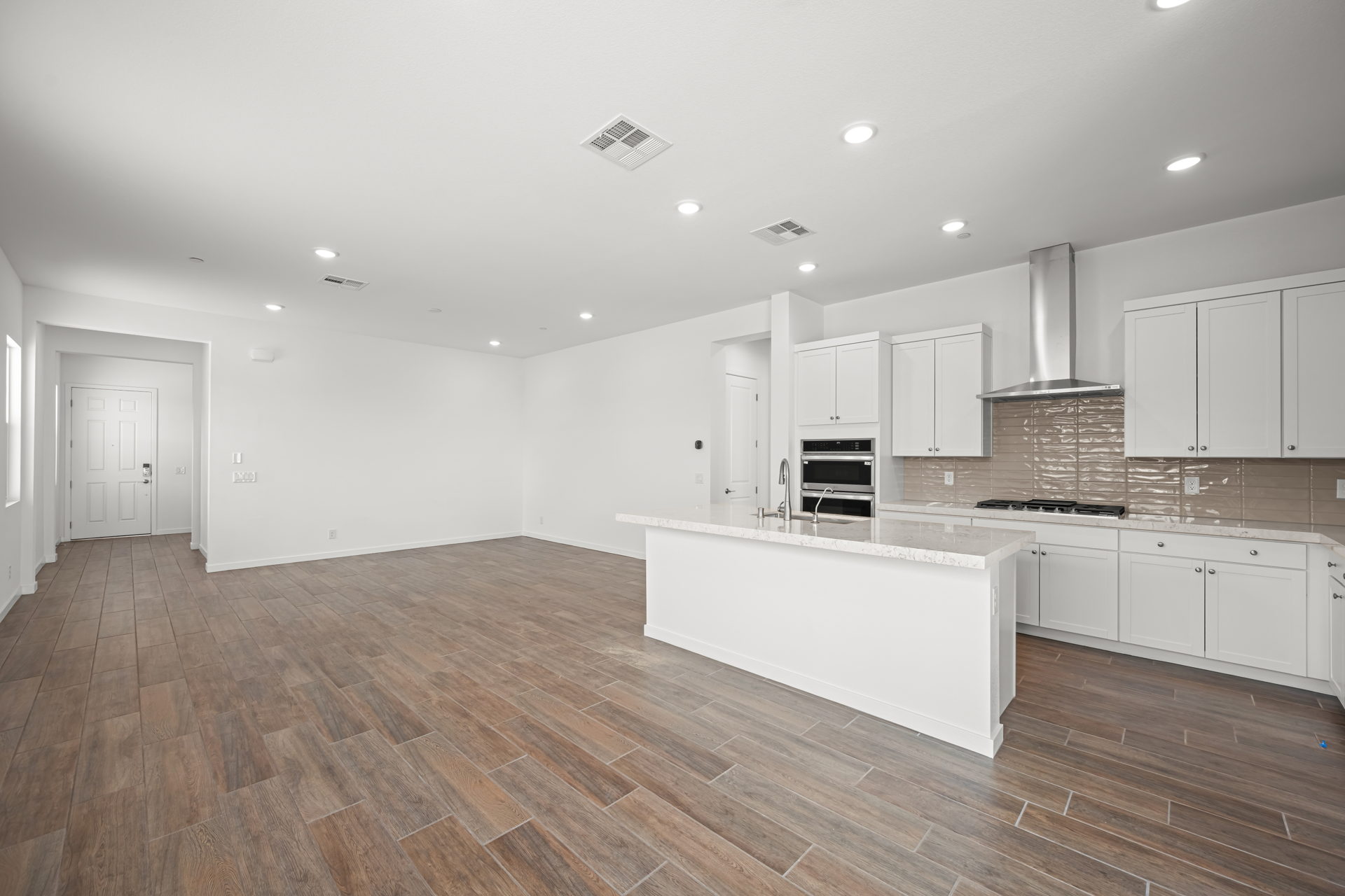A kitchen with white cabinets.