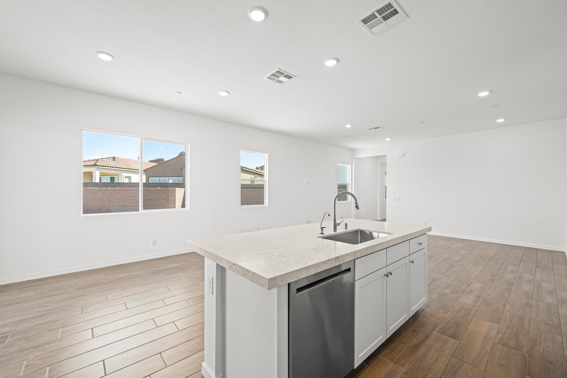 A kitchen with white cabinets.