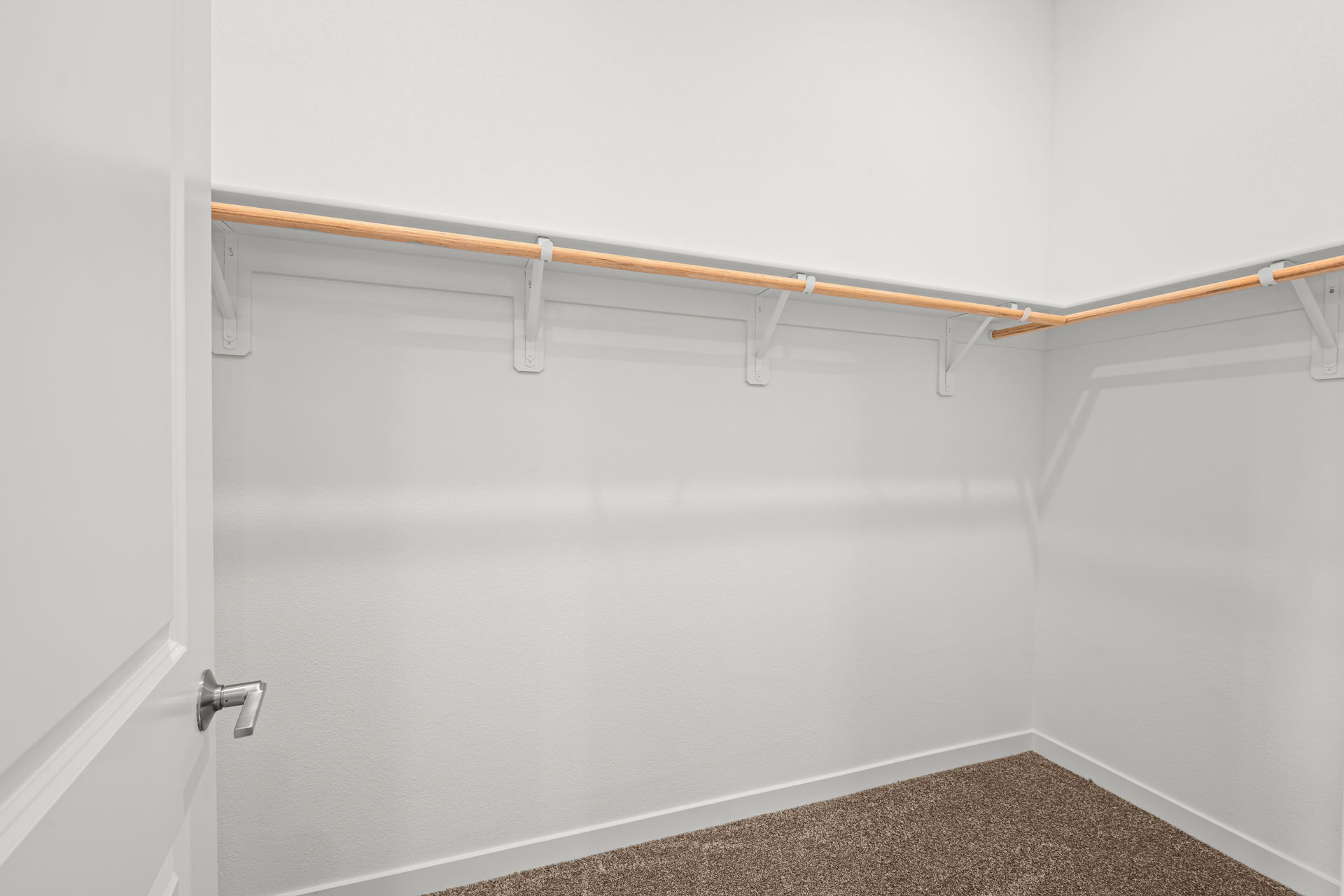A white door with a wooden handle.