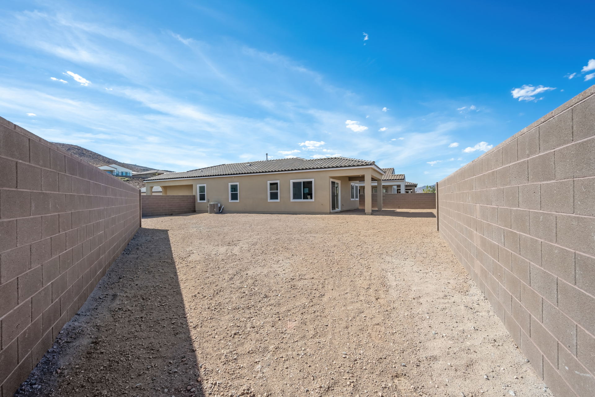 A building with a dirt road.