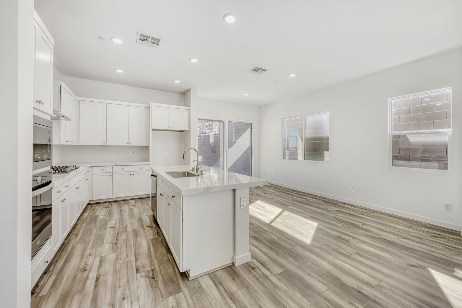 A kitchen with white cabinets.