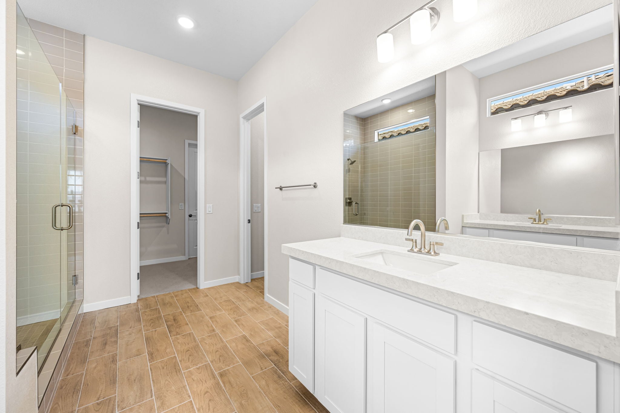 A bathroom with a large mirror.