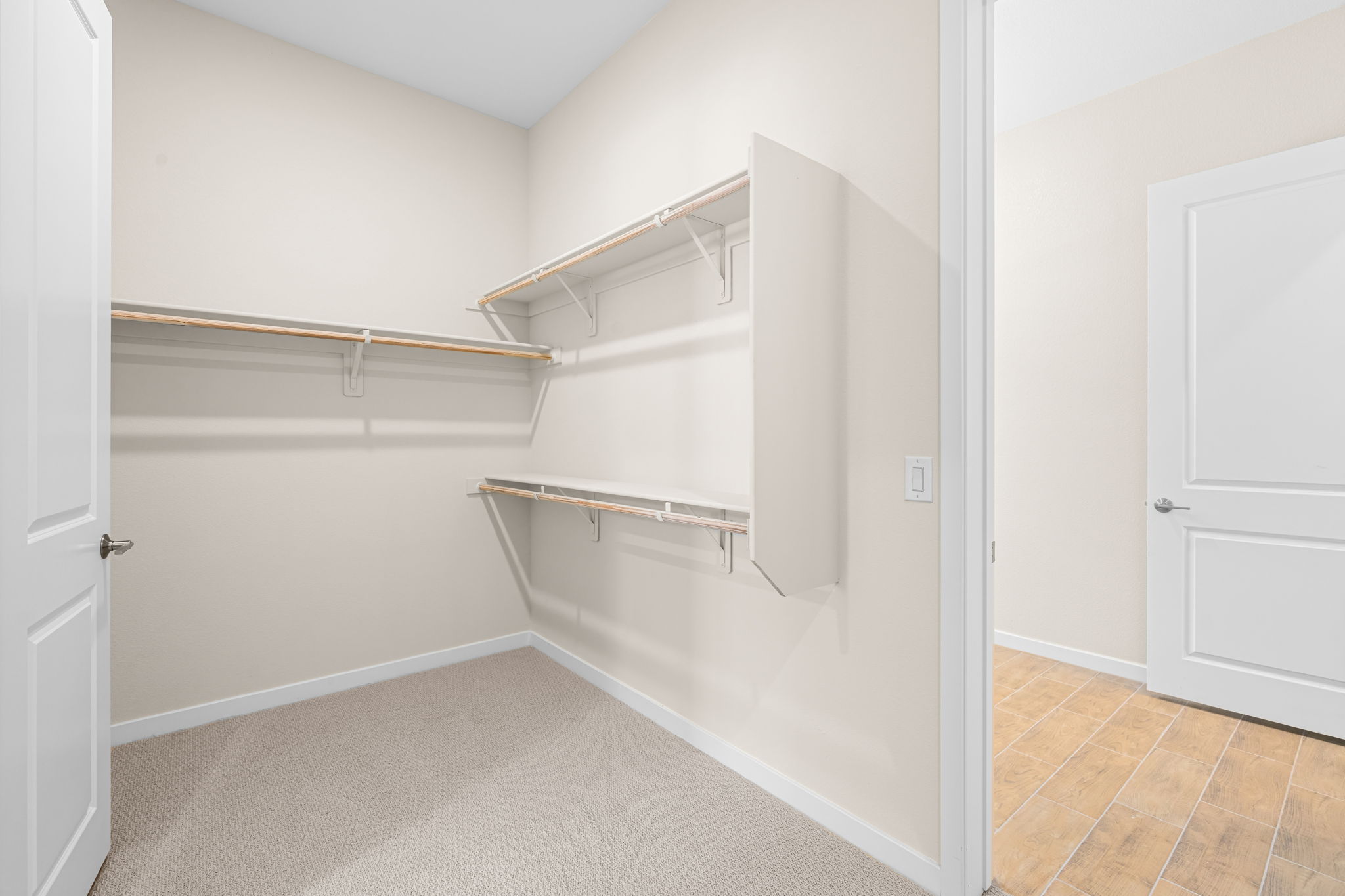 A white bathroom with a shower unit.