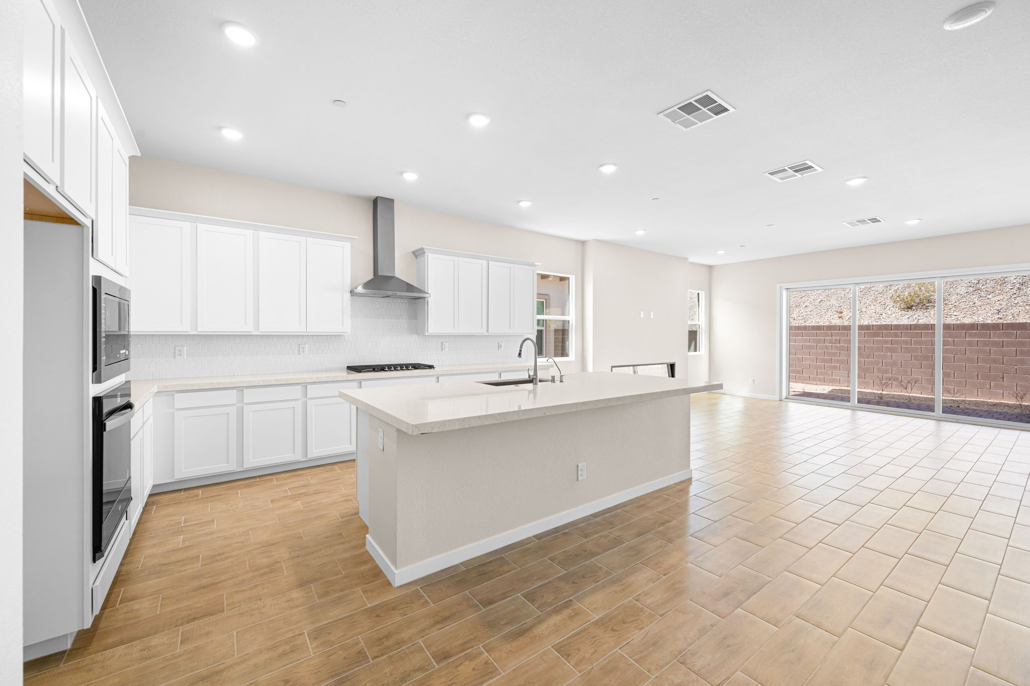 A kitchen with white cabinets.