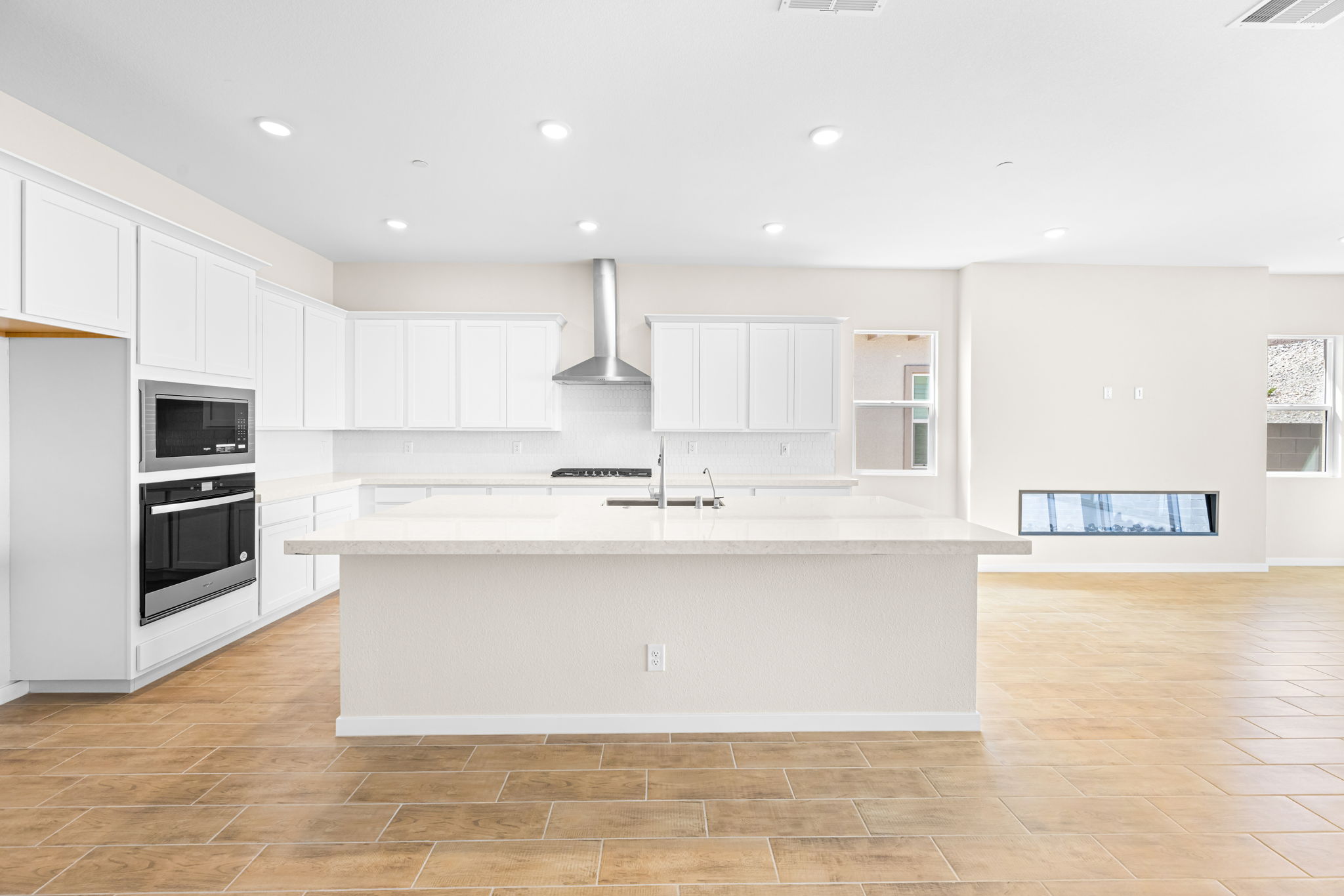 A kitchen with white cabinets.