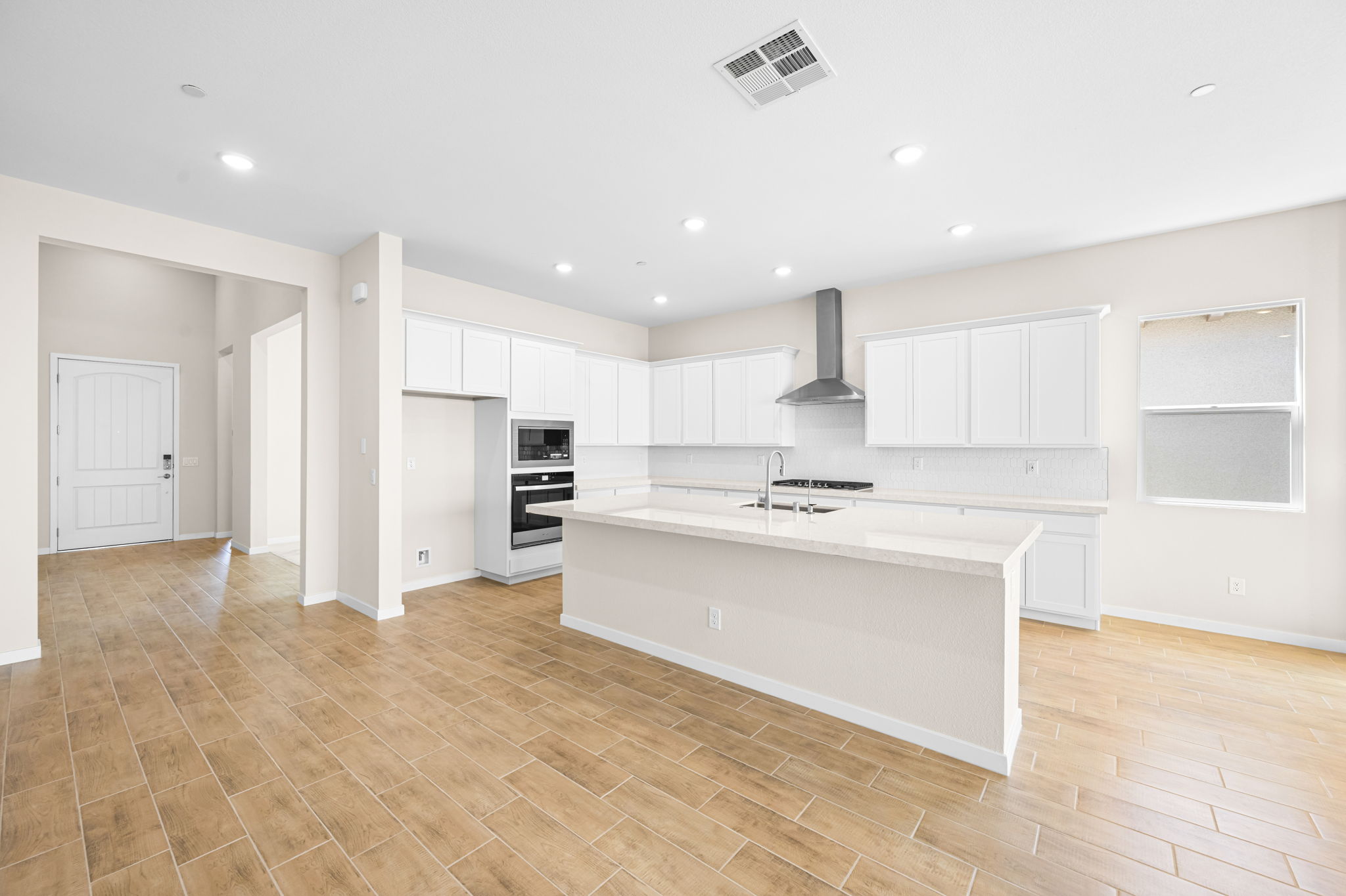A kitchen with white cabinets.