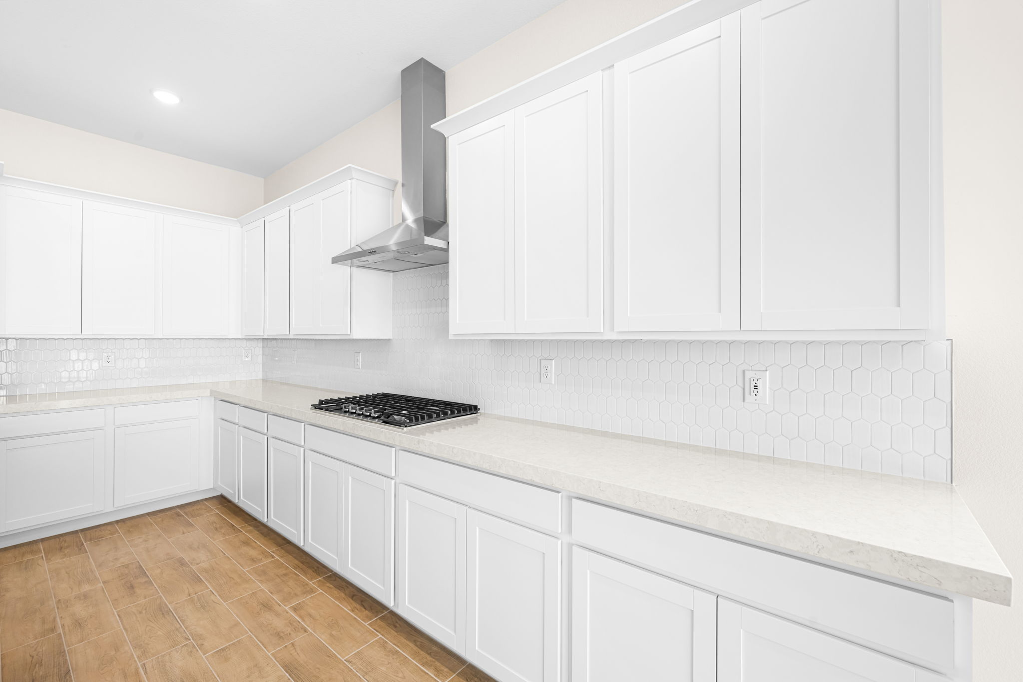 A kitchen with white cabinets.