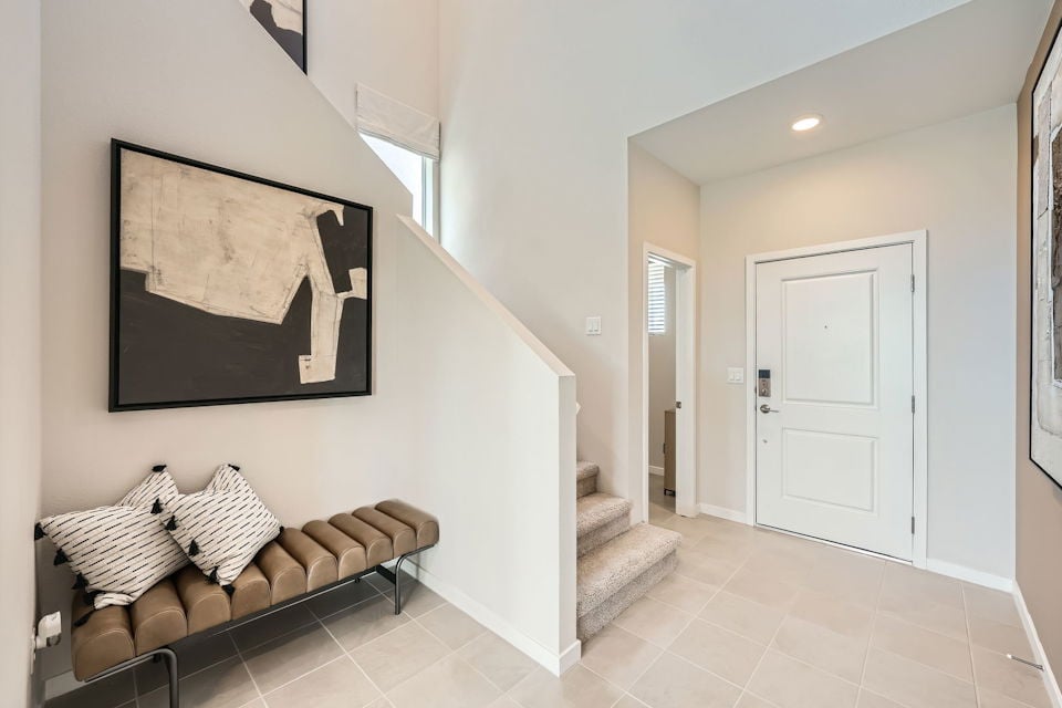 A room with a couch and a painting on the wall.