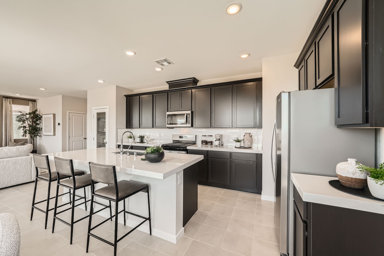 A kitchen with black cabinets.