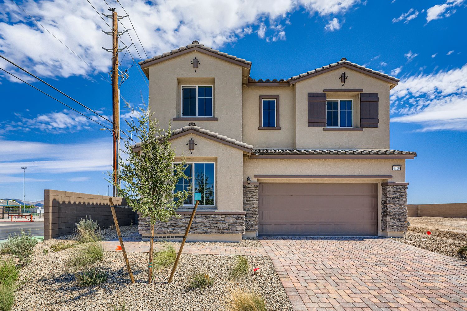 A house with a brick driveway.