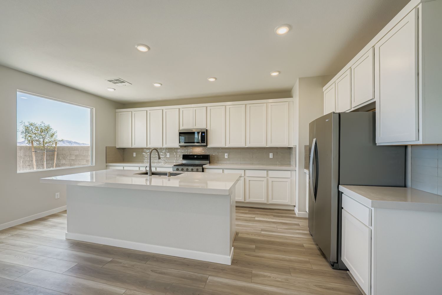 A kitchen with white cabinets.