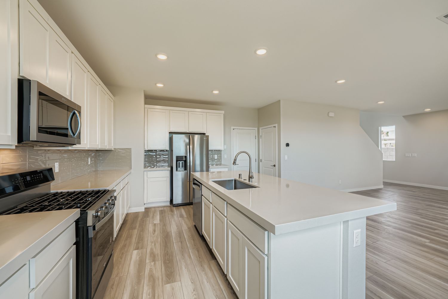 A kitchen with white cabinets.