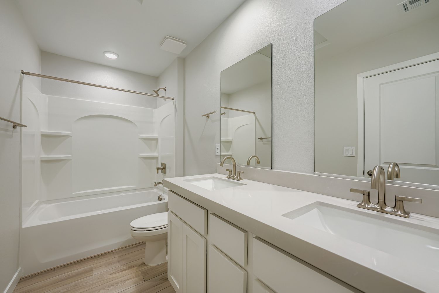 A bathroom with a tub sink and toilet.