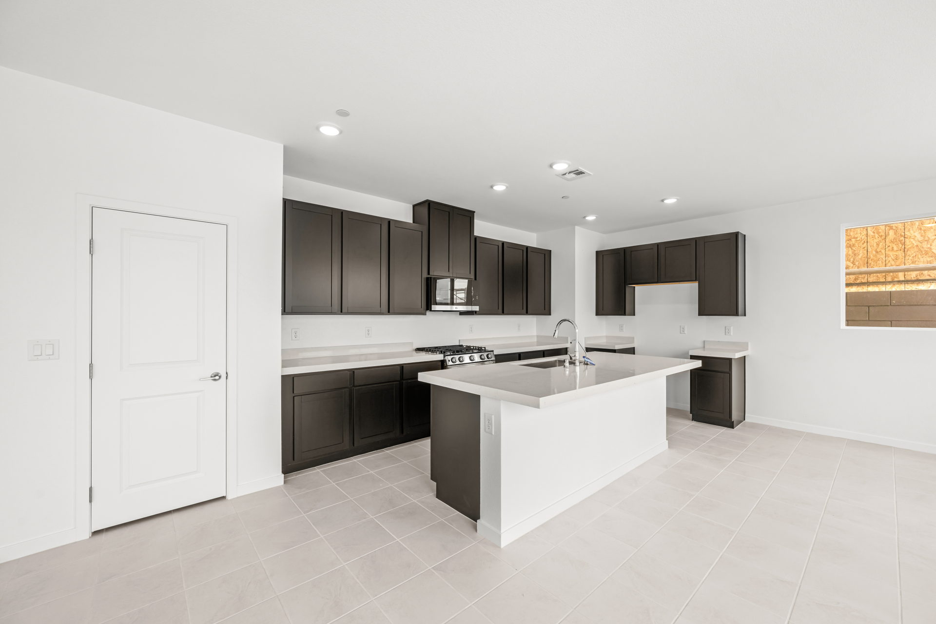 A kitchen with black cabinets.