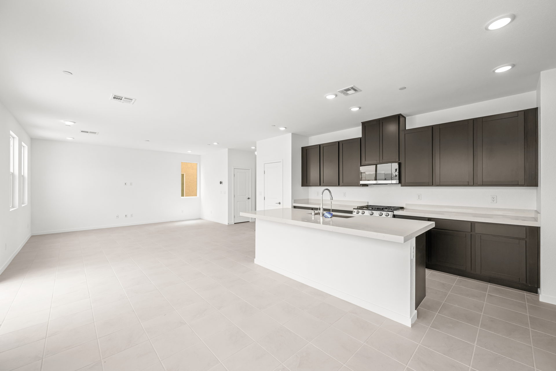 A large kitchen with black cabinets.