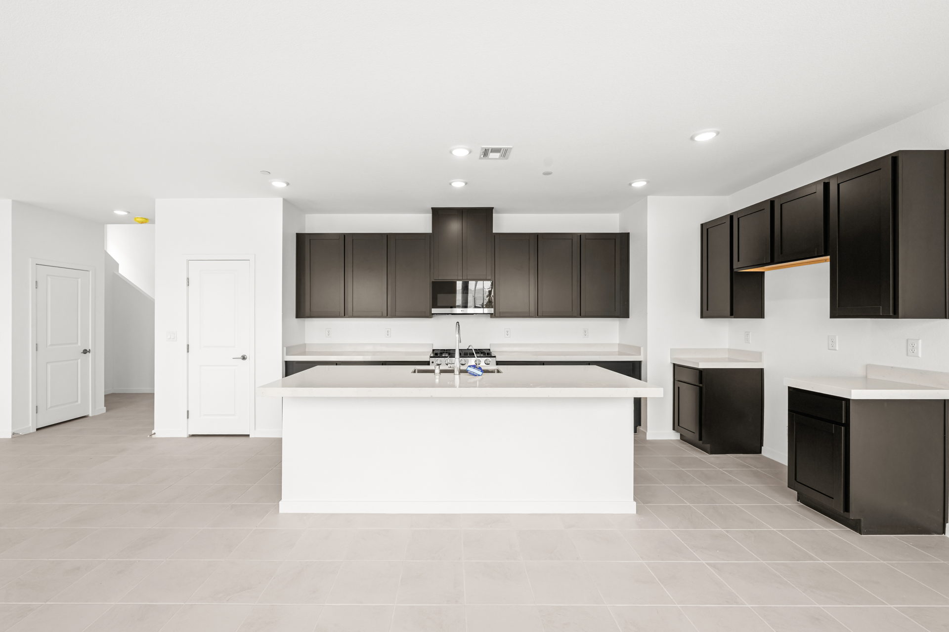 A kitchen with black cabinets.