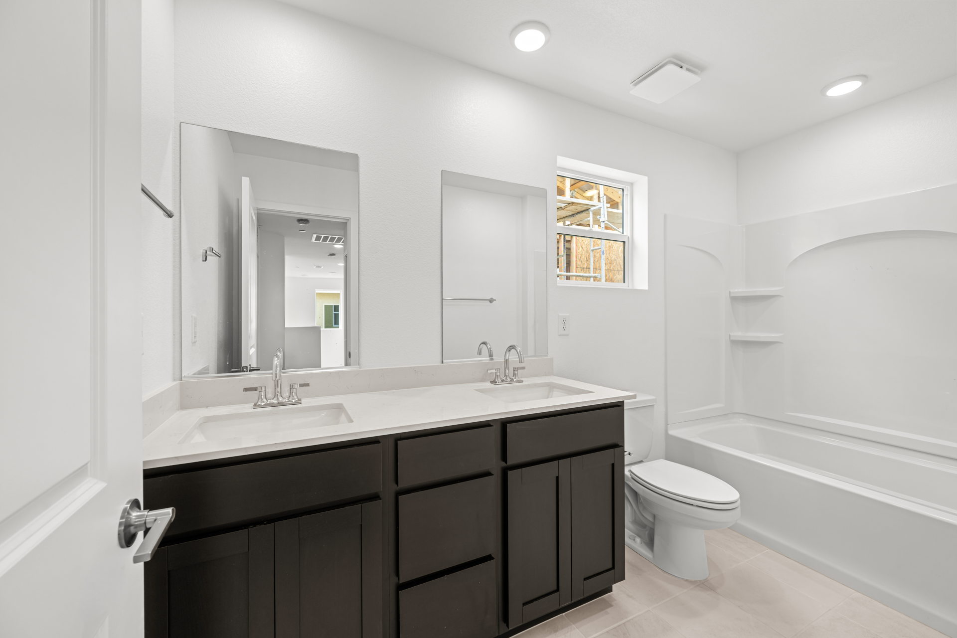 A bathroom with a tub sink and toilet.
