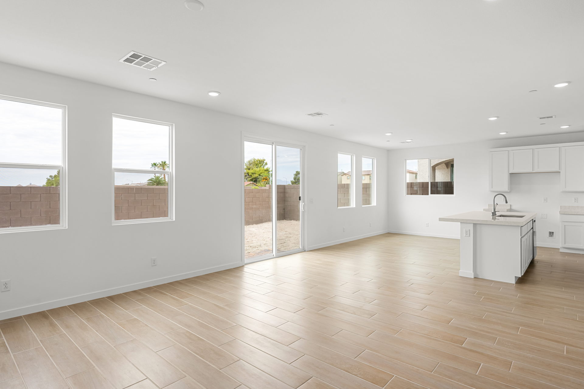 A large white room with a wood floor and a wood floor.