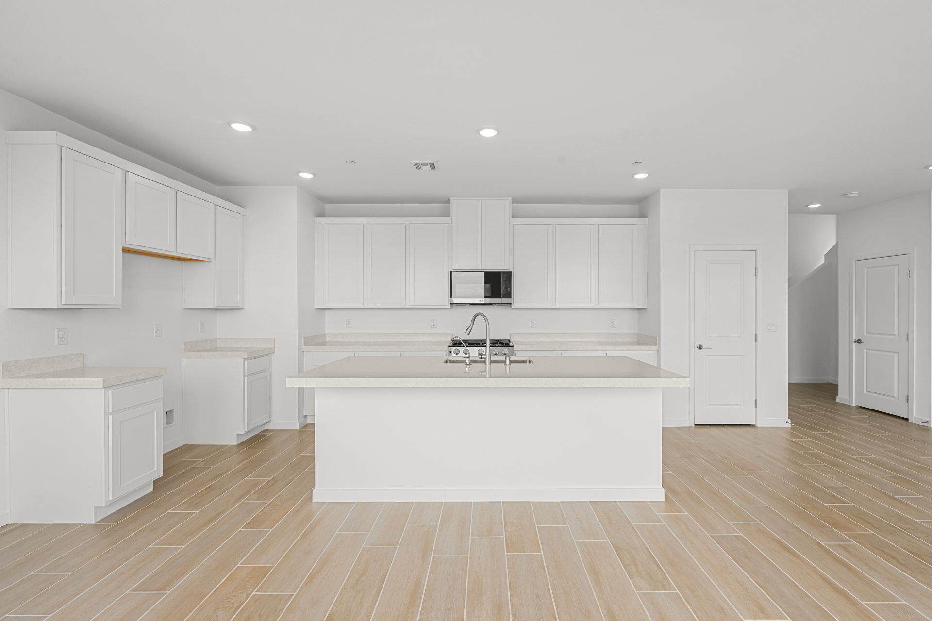 A large kitchen with white cabinets.
