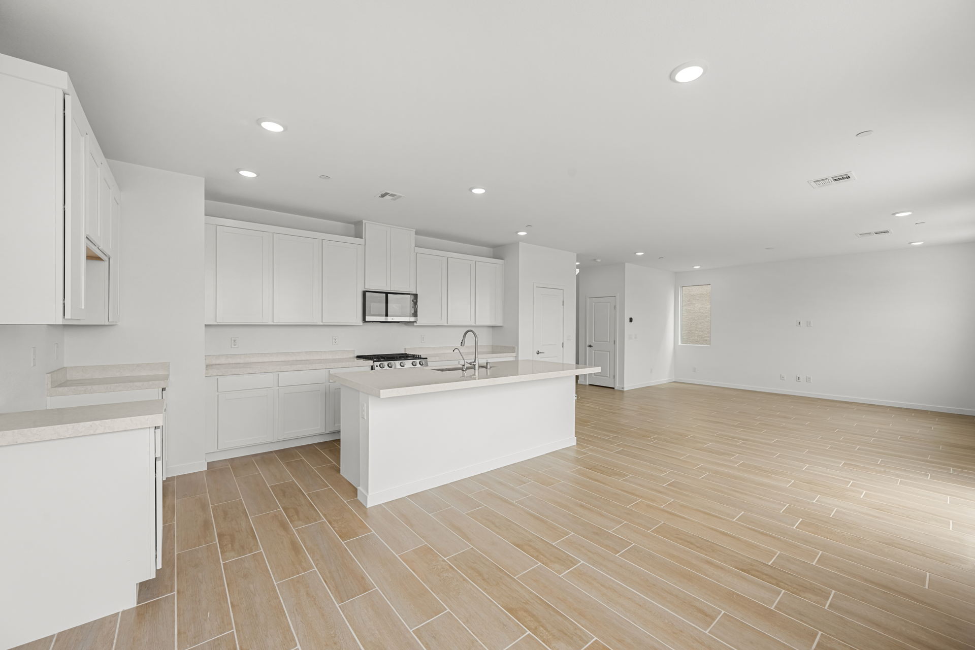A kitchen with white cabinets.