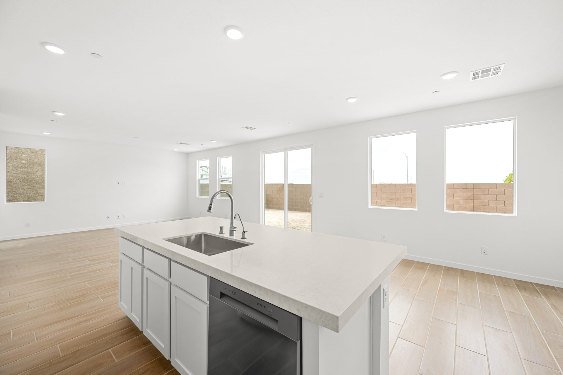 A kitchen with white cabinets.